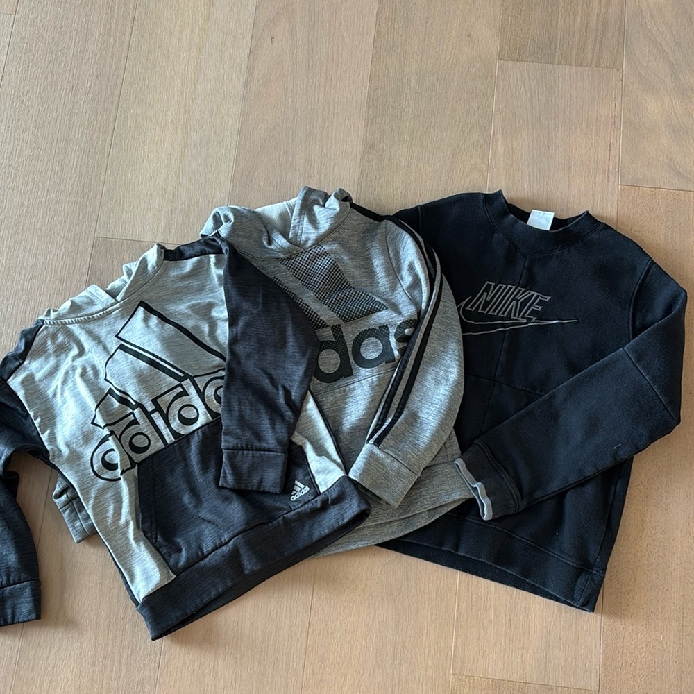 Three boys sweatshirts, two Adidas hoodies and one Nike.